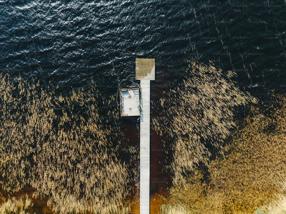 an aerial view of a dock in a body of water