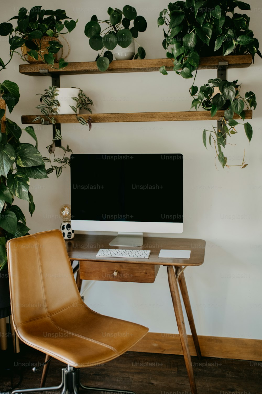 a desk with a computer and a chair