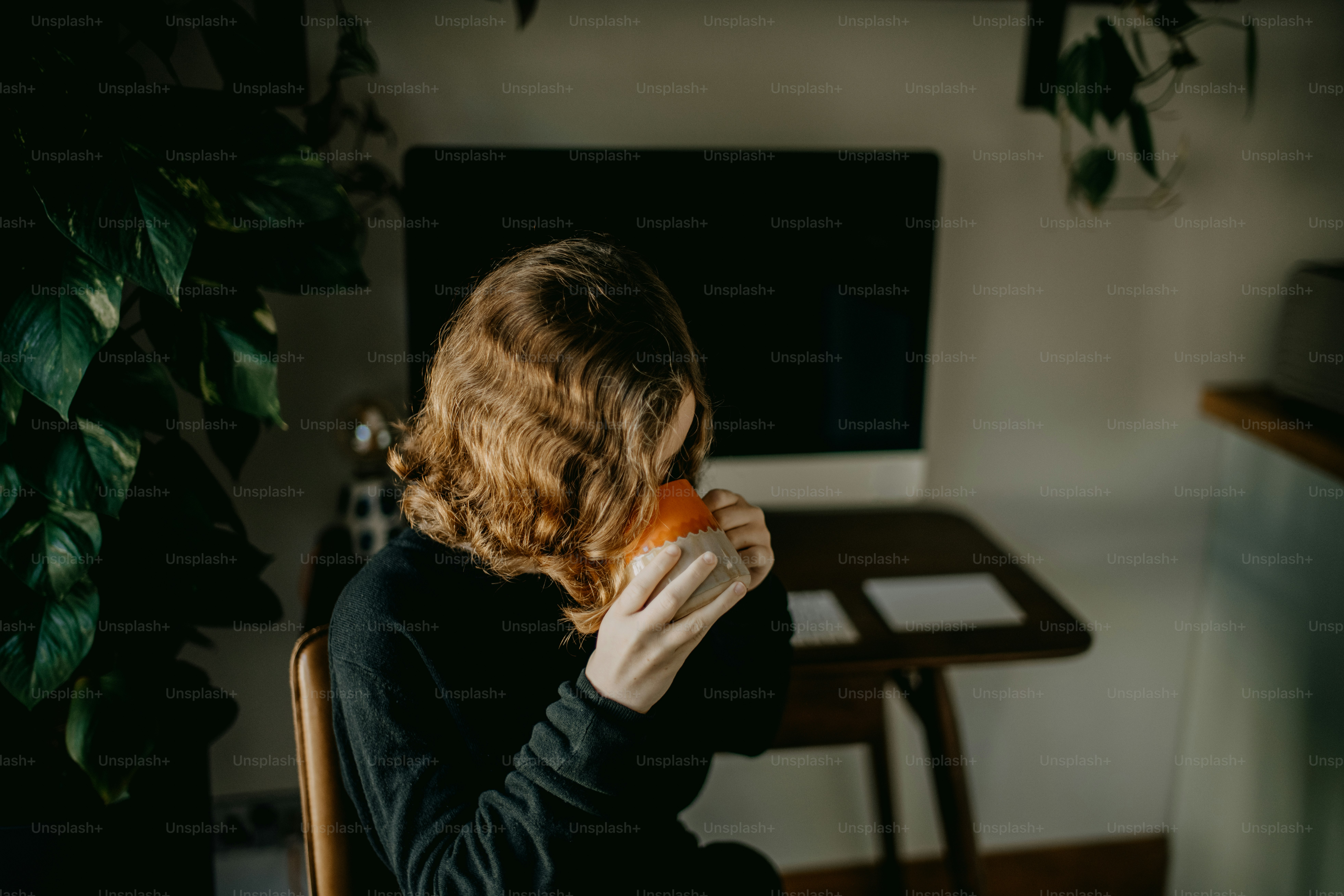 a woman sitting in a chair holding a piece of food