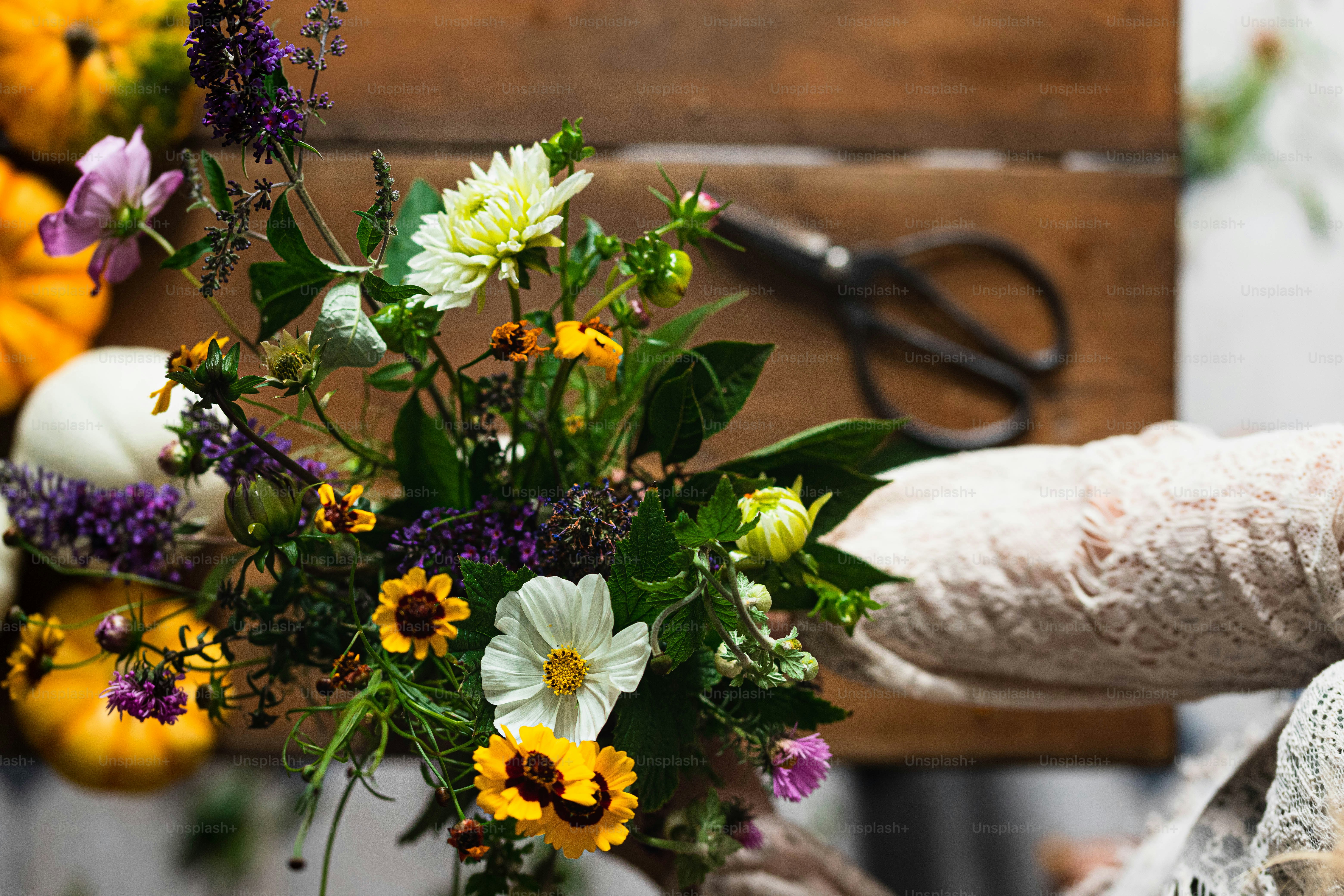 a bouquet of flowers is being held by a woman