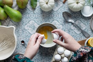 a person is peeling an egg into a bowl