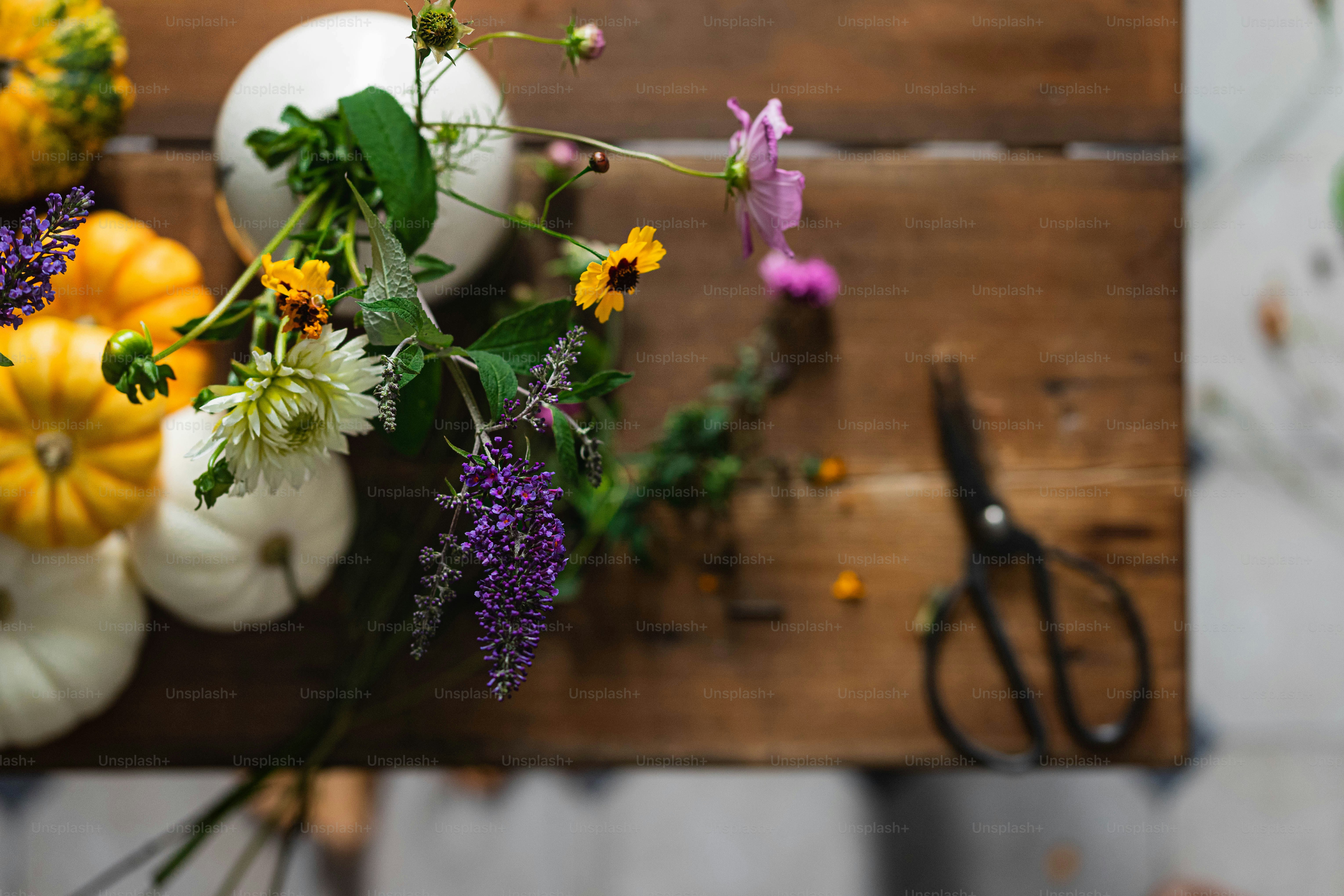 a bunch of flowers sitting on top of a wooden table