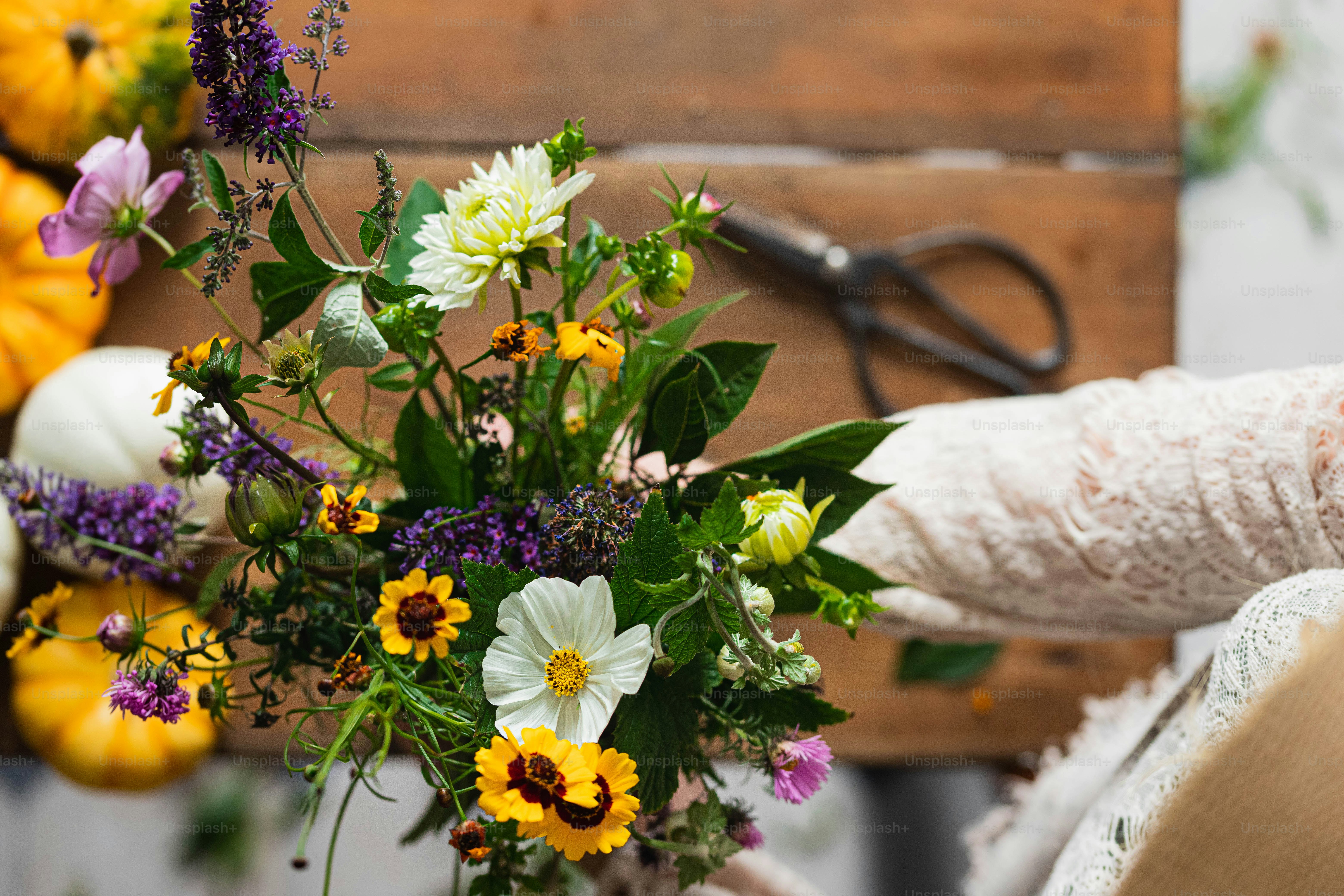a woman is holding a bouquet of flowers