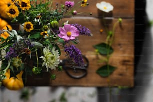 a bunch of flowers sitting on top of a wooden box