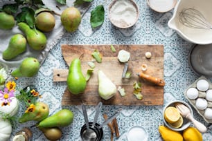 a wooden cutting board topped with lots of fruit