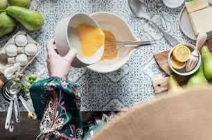 a person mixing something in a bowl with a whisk