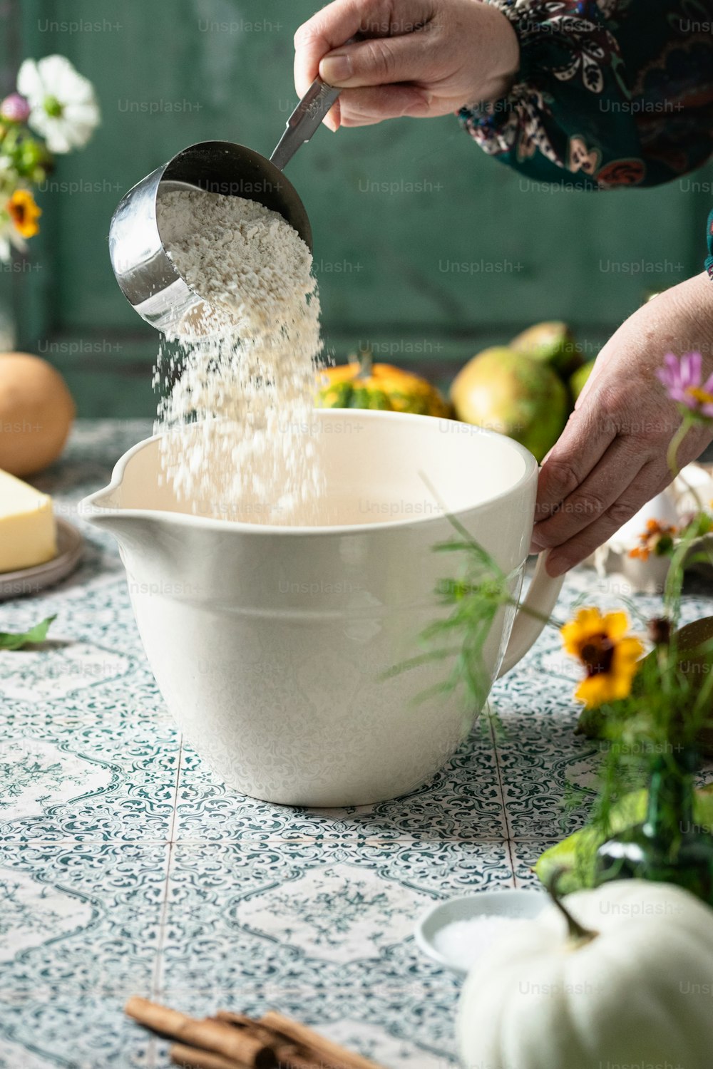 a person pouring rice into a white bowl
