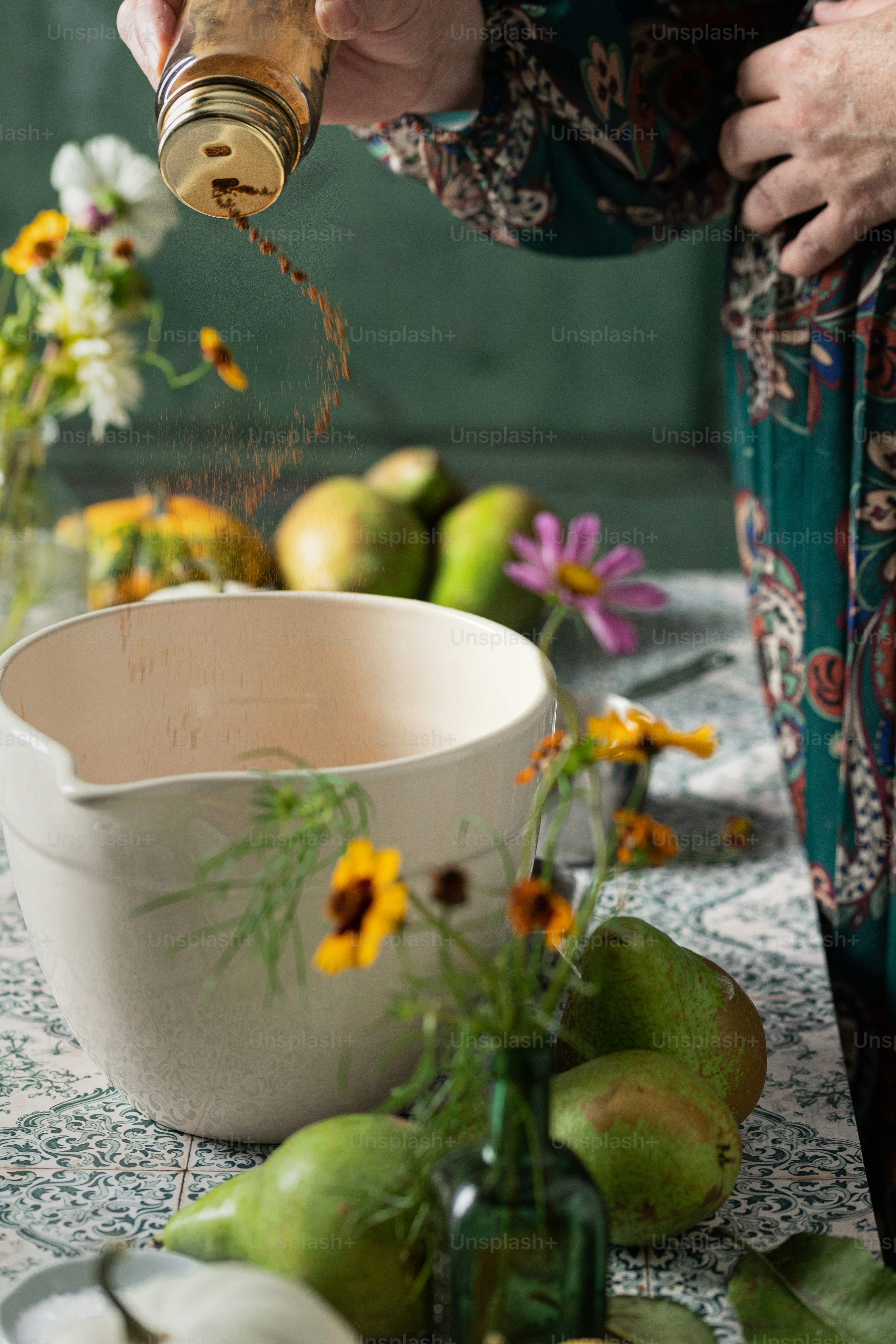 a person pouring a drink into a white bowl