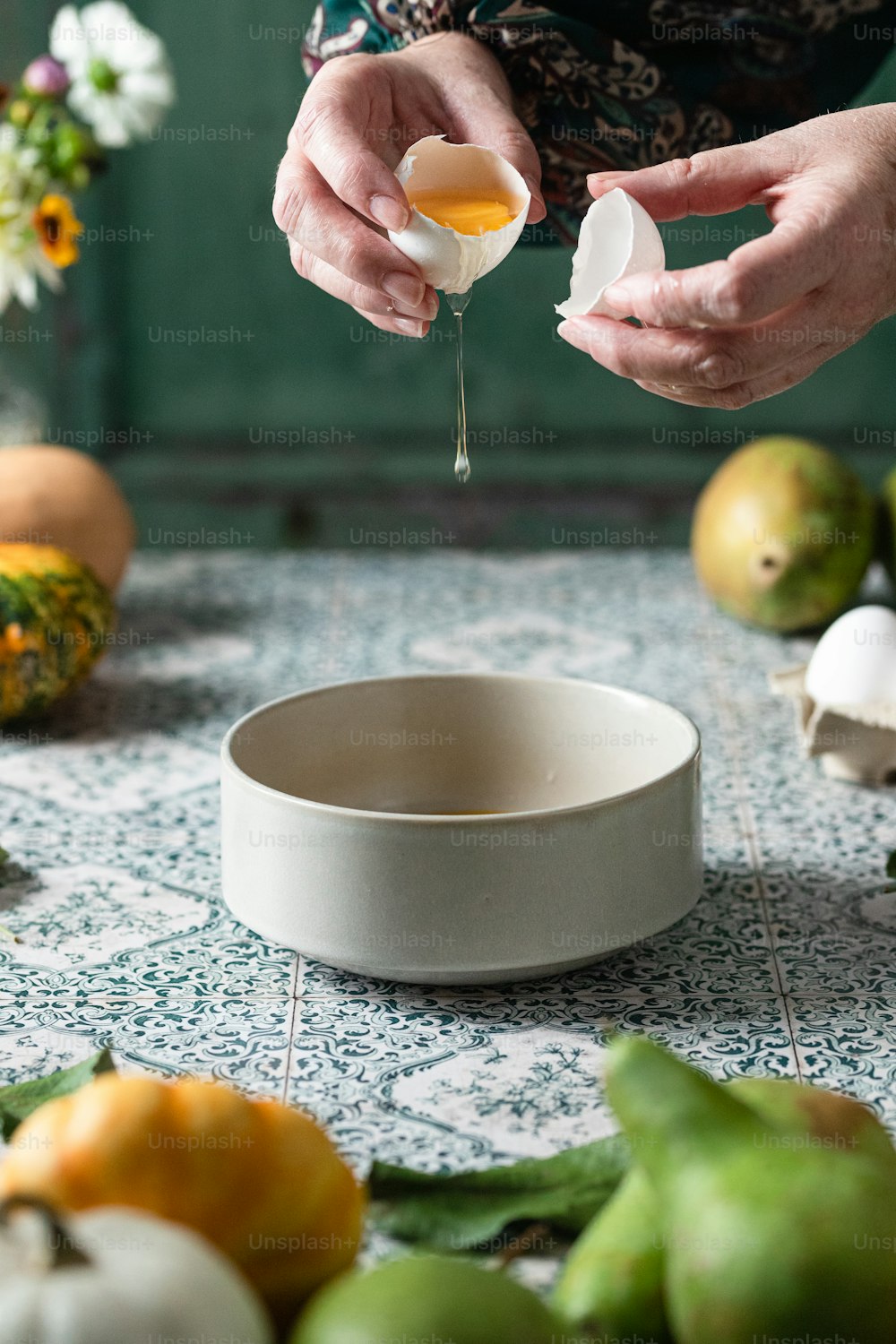 a person pouring an egg into a bowl