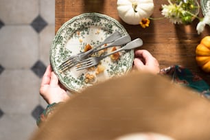 a person sitting at a table with a plate of food