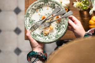 a person holding a plate with food on it