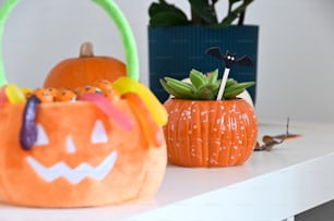 a pumpkin shaped purse sitting on top of a white shelf