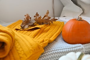 a blanket and a pumpkin on a bed
