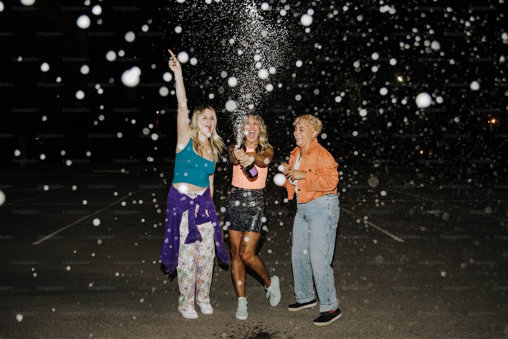 a group of three women standing next to each other