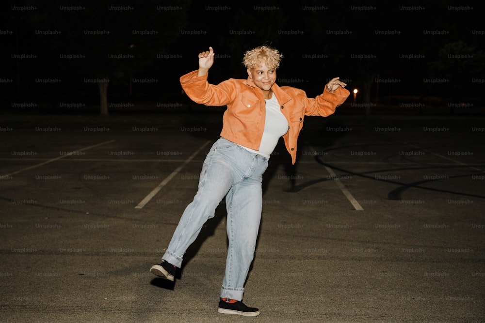 a man in an orange jacket is doing a trick on a skateboard