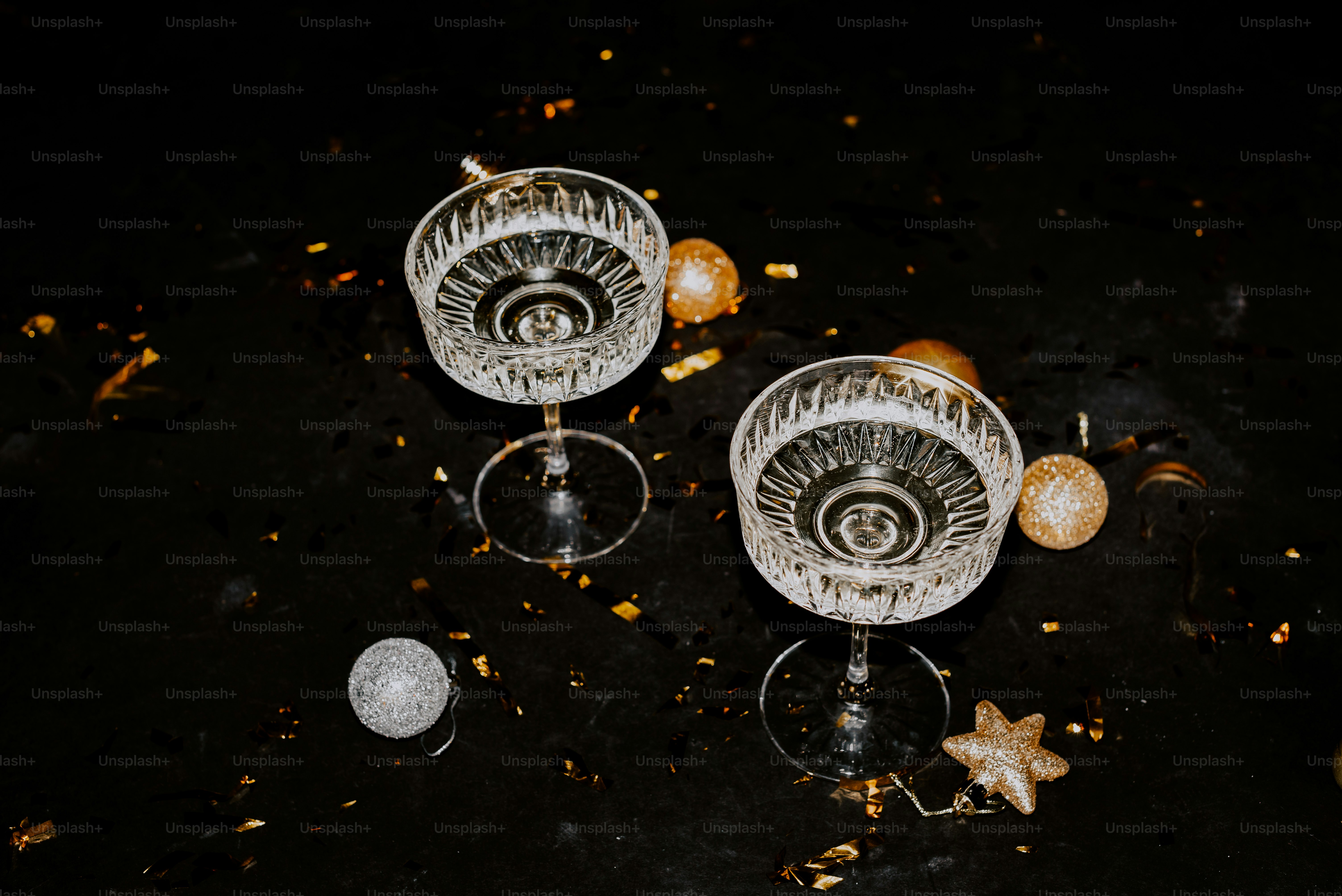 two wine glasses sitting on top of a table