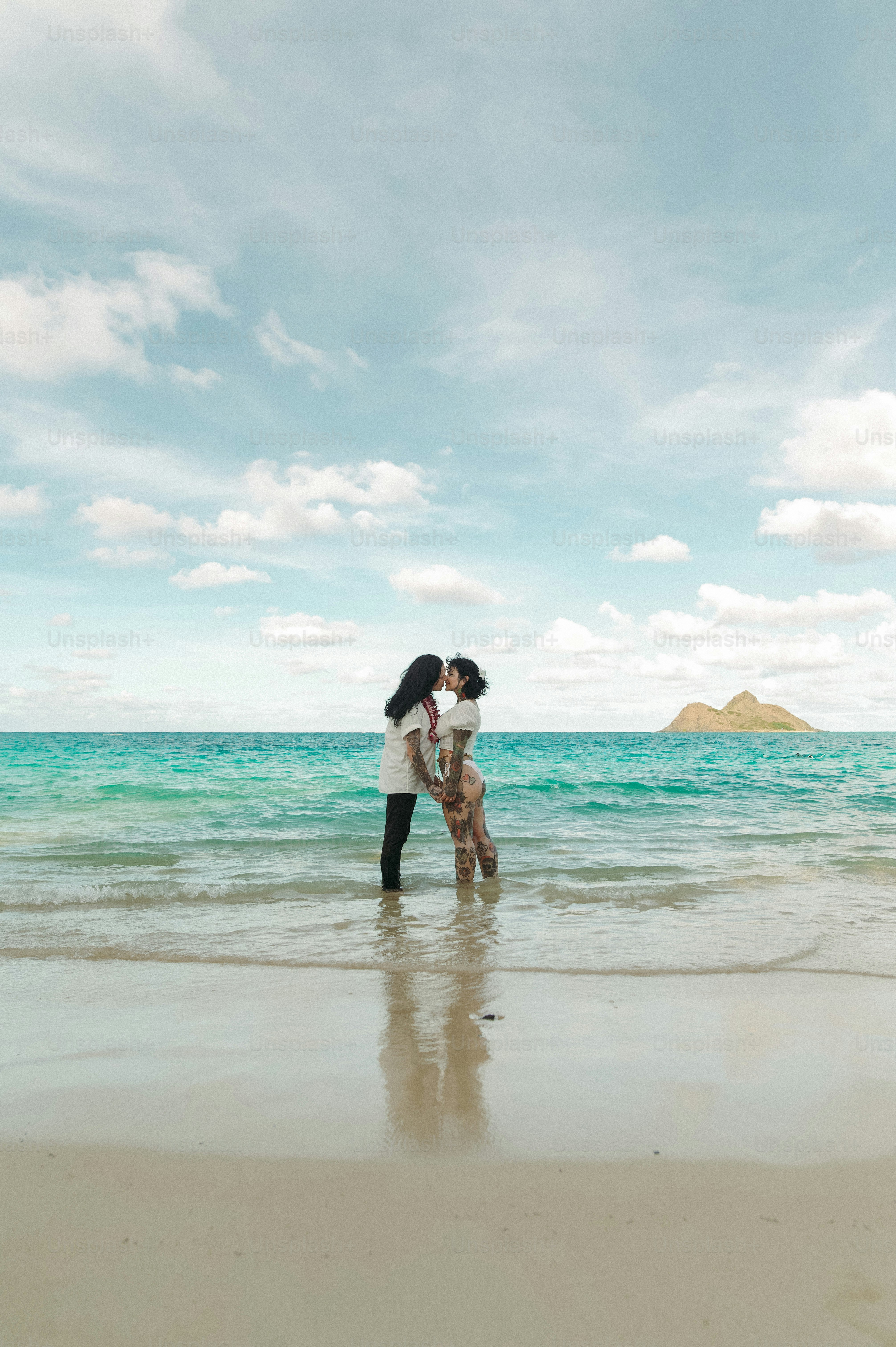 a couple of people that are standing in the water