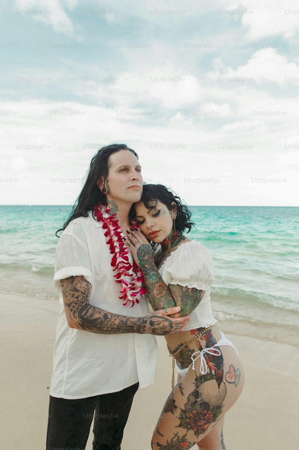 a couple of people that are standing in the sand