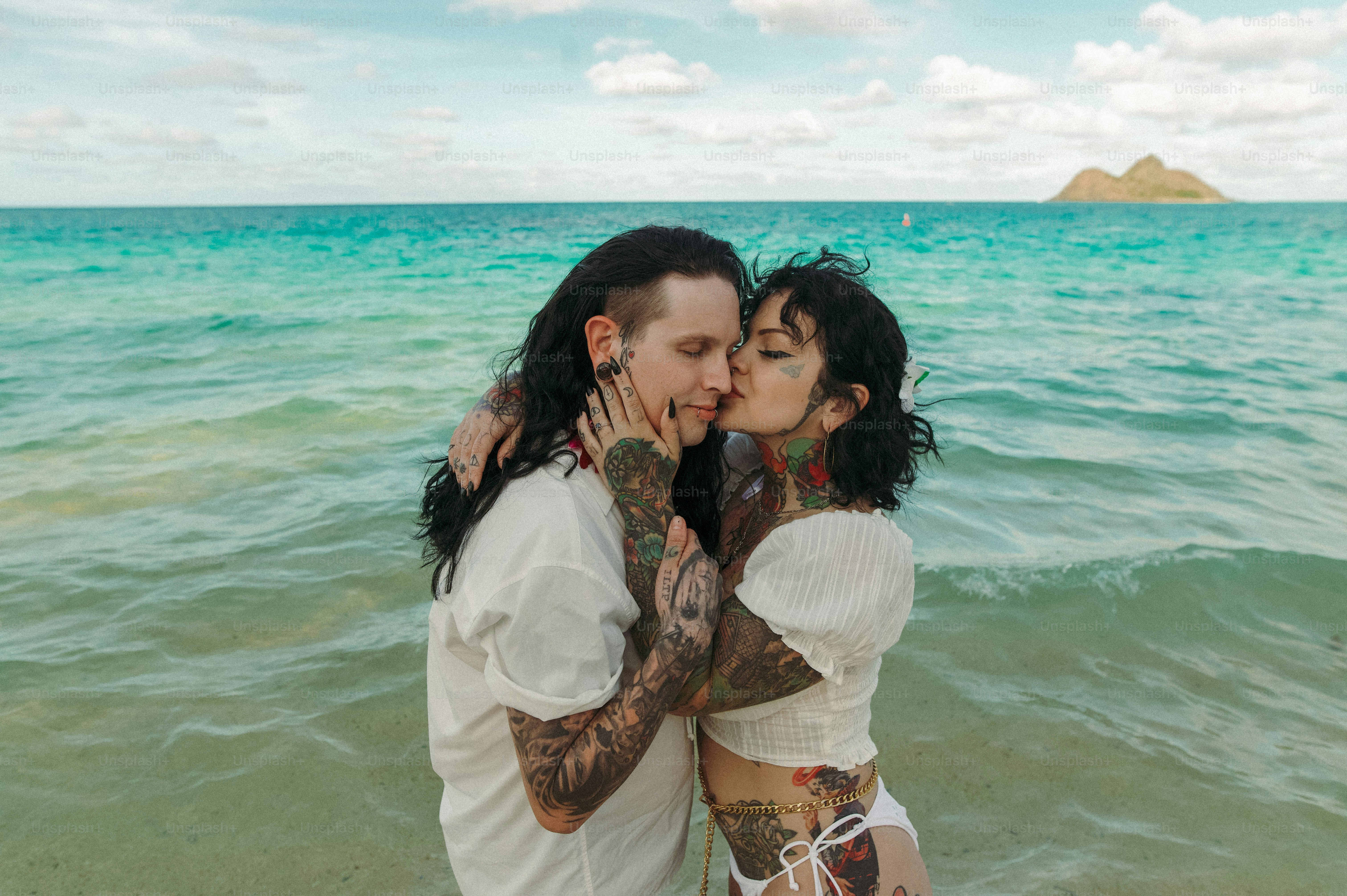 a couple of people that are standing in the water