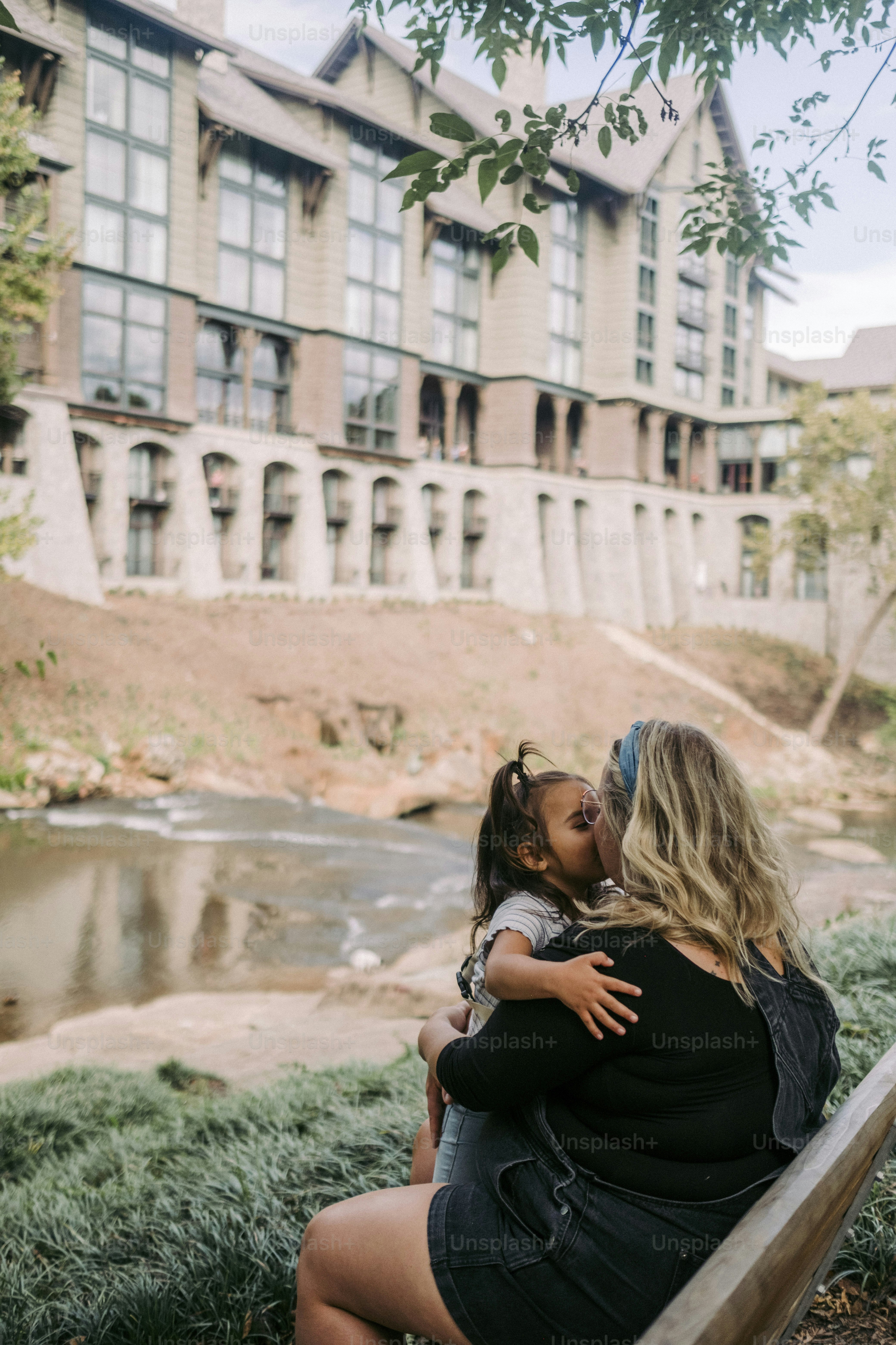a woman sitting on a bench with a child