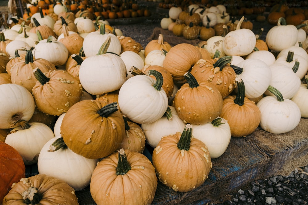 a pile of pumpkins sitting on top of a table