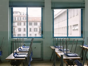 a row of desks in front of a window