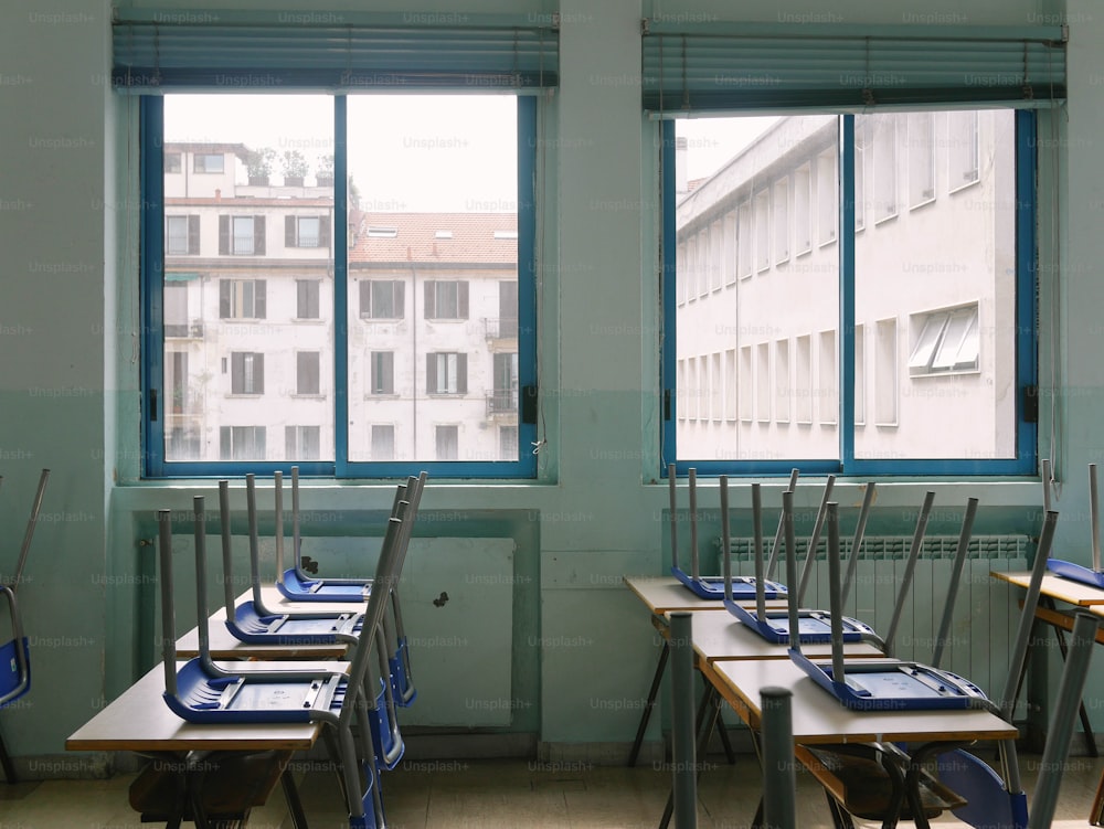 a row of desks in front of a window