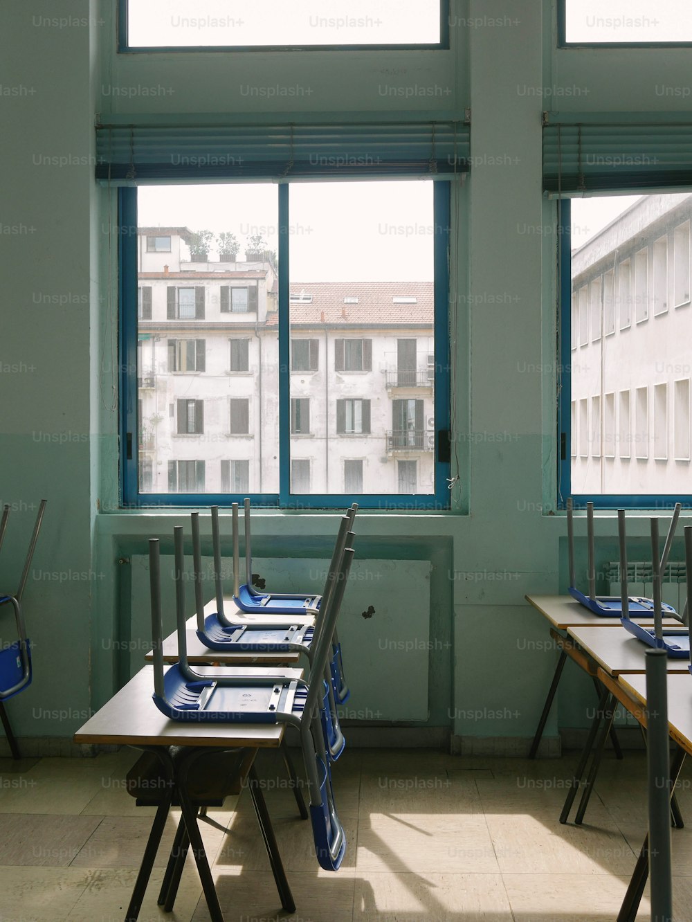 a row of desks in front of a window