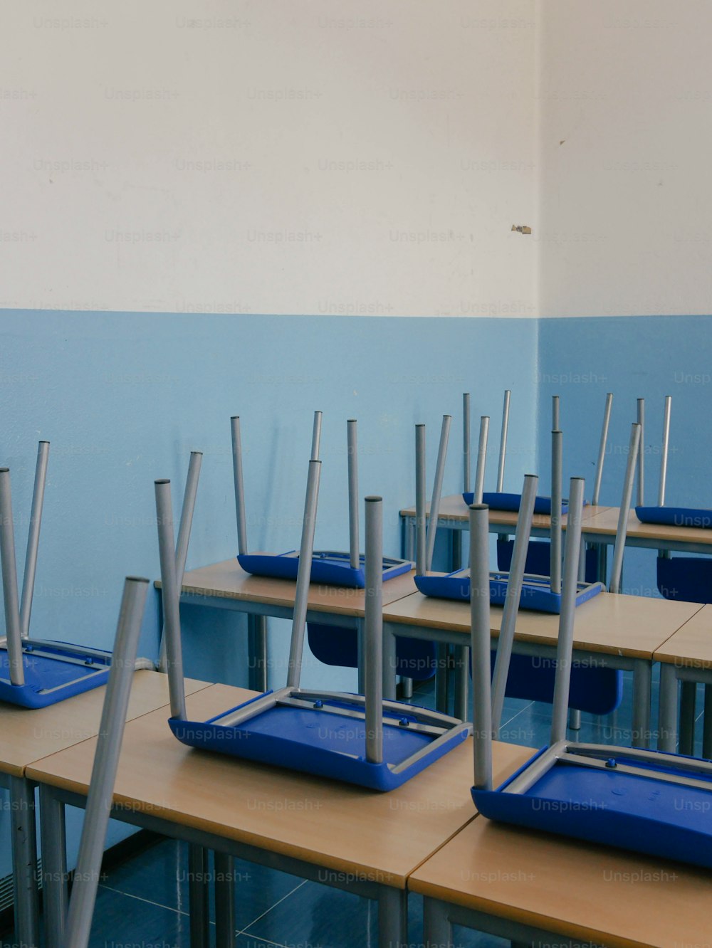 a row of desks with blue trays on top of them