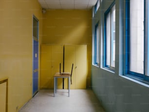 a yellow room with a chair and a yellow locker