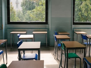 a classroom with desks and a large window