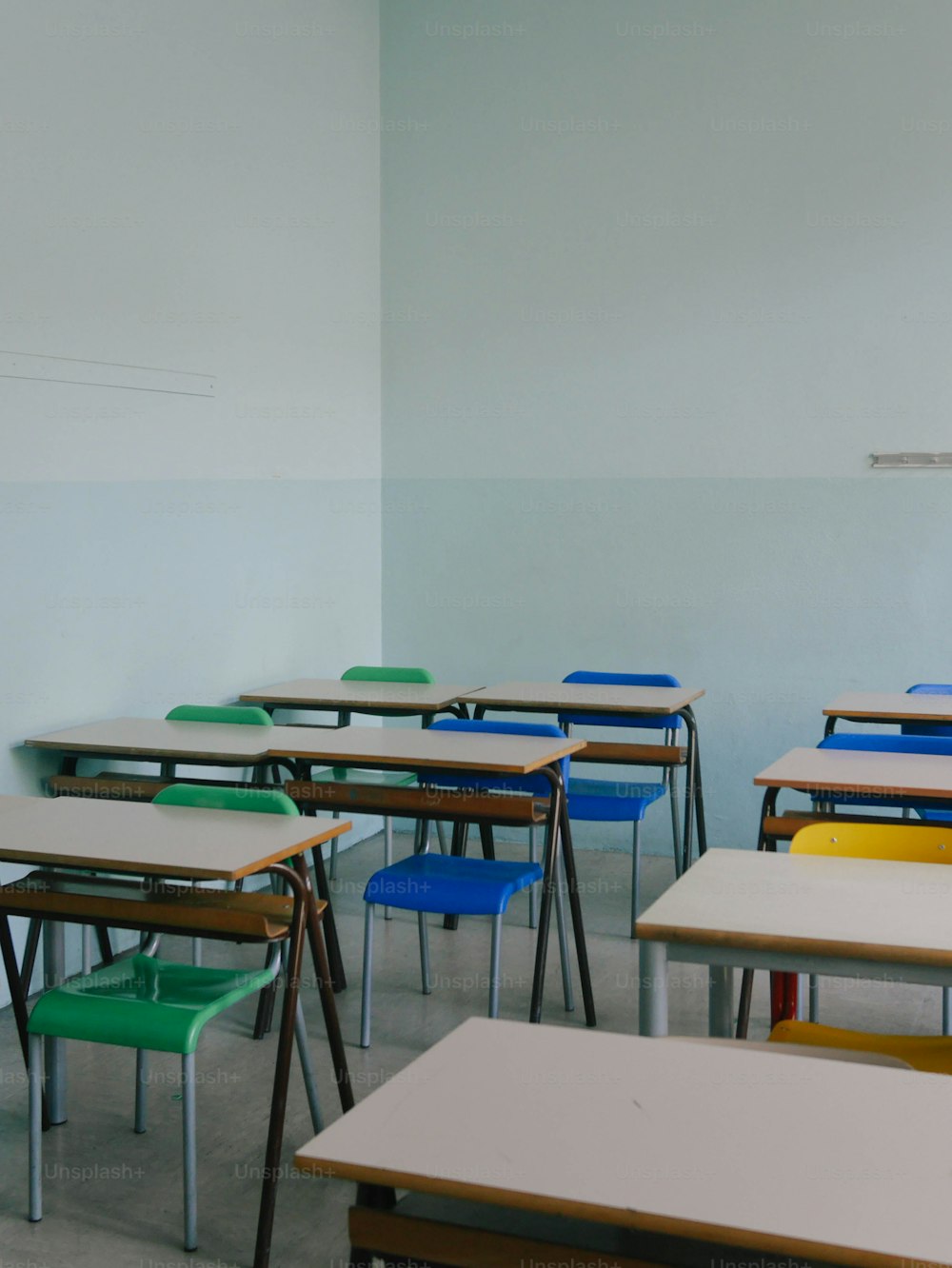 a classroom with a row of desks and chairs