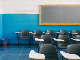 a classroom with a chalk board and chairs