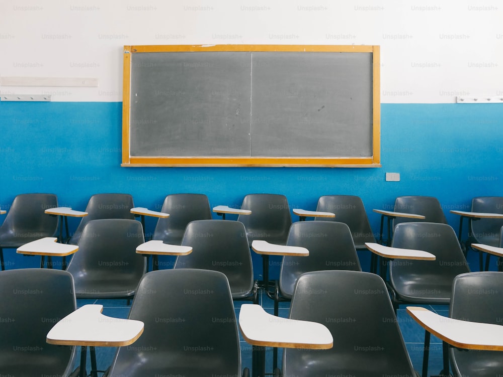 a classroom with a chalkboard and chairs