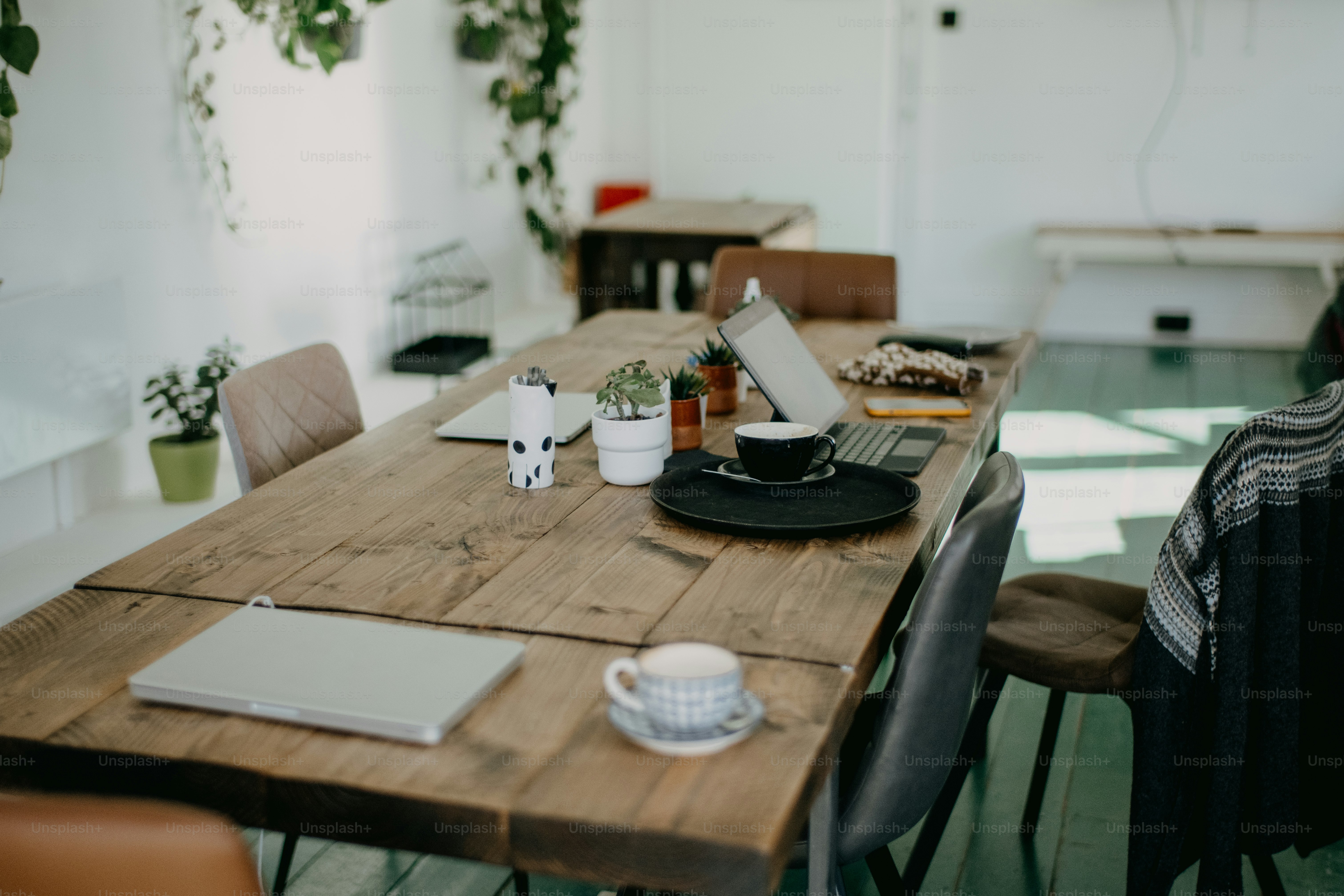 a wooden table topped with a laptop computer