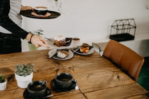 a woman holding a plate with desserts on it