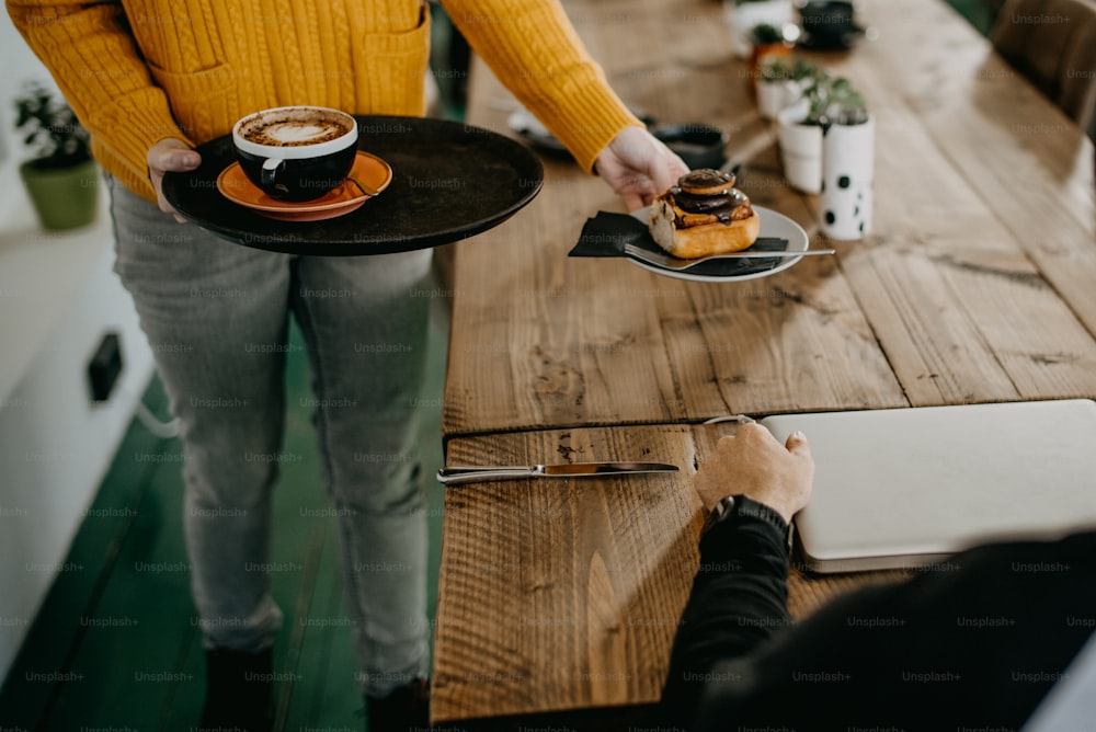 a person holding a plate with food on it