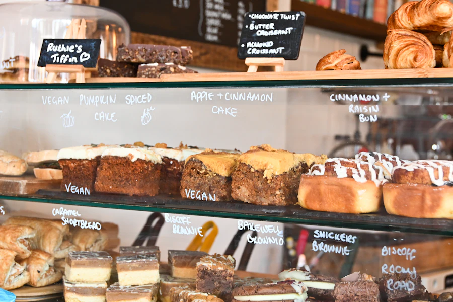 A café counter filled with pastries and coffee equipment