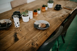 a wooden table topped with plates of food