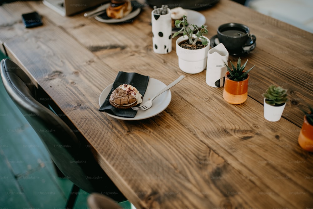 a wooden table topped with plates of food