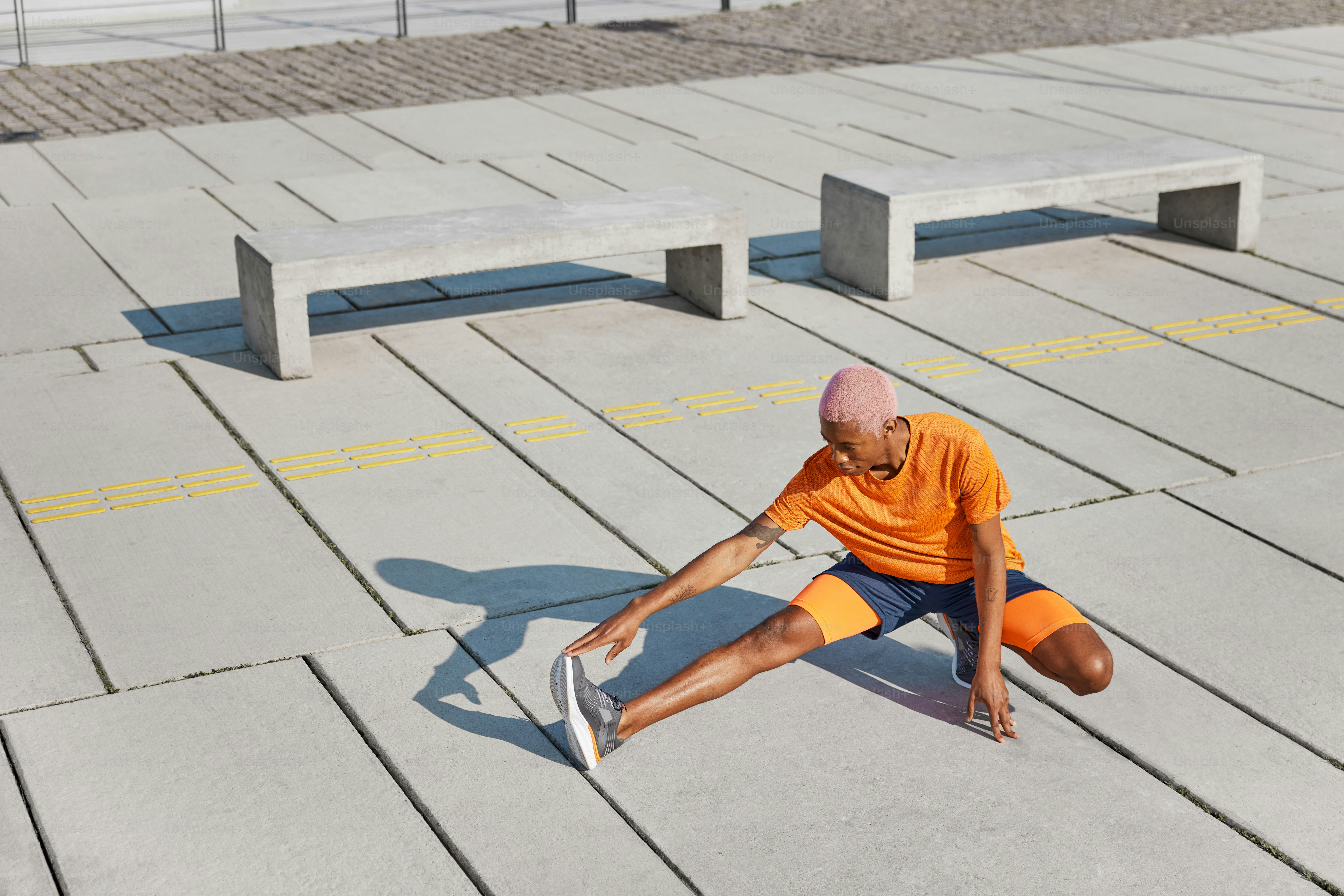 a man sitting on the ground with a skateboard