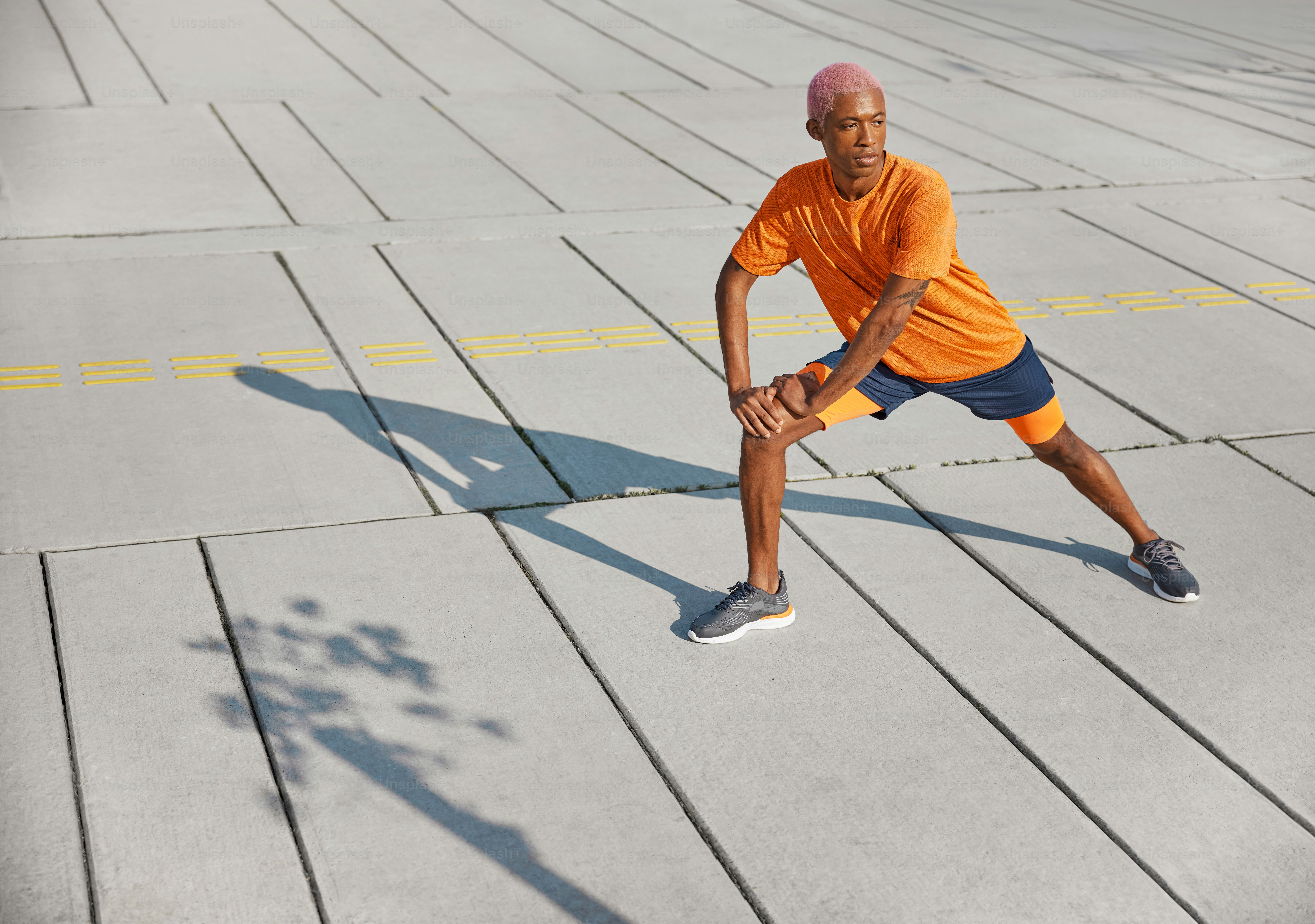 a man in an orange shirt is playing tennis