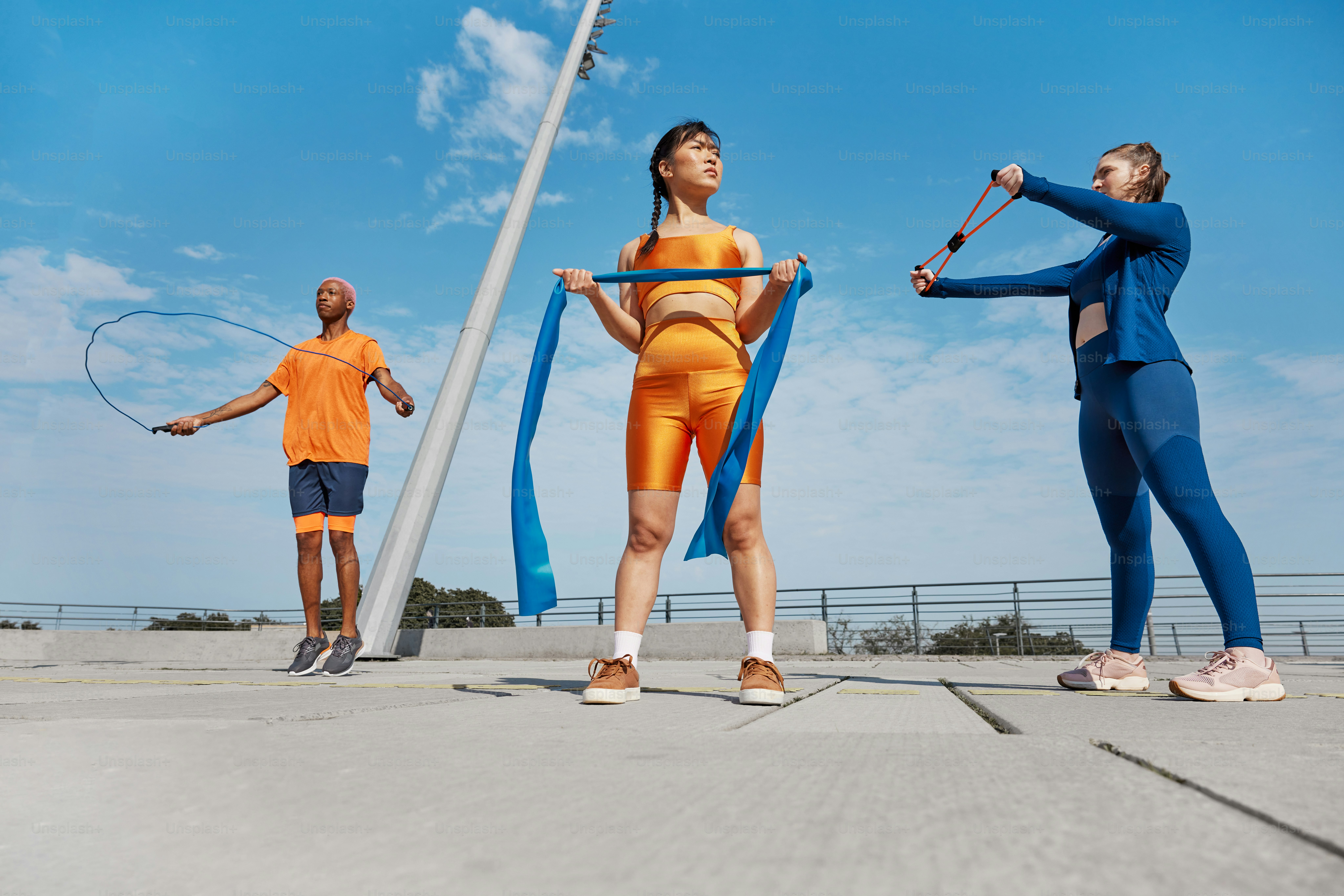 a group of people standing around each other holding tennis racquets