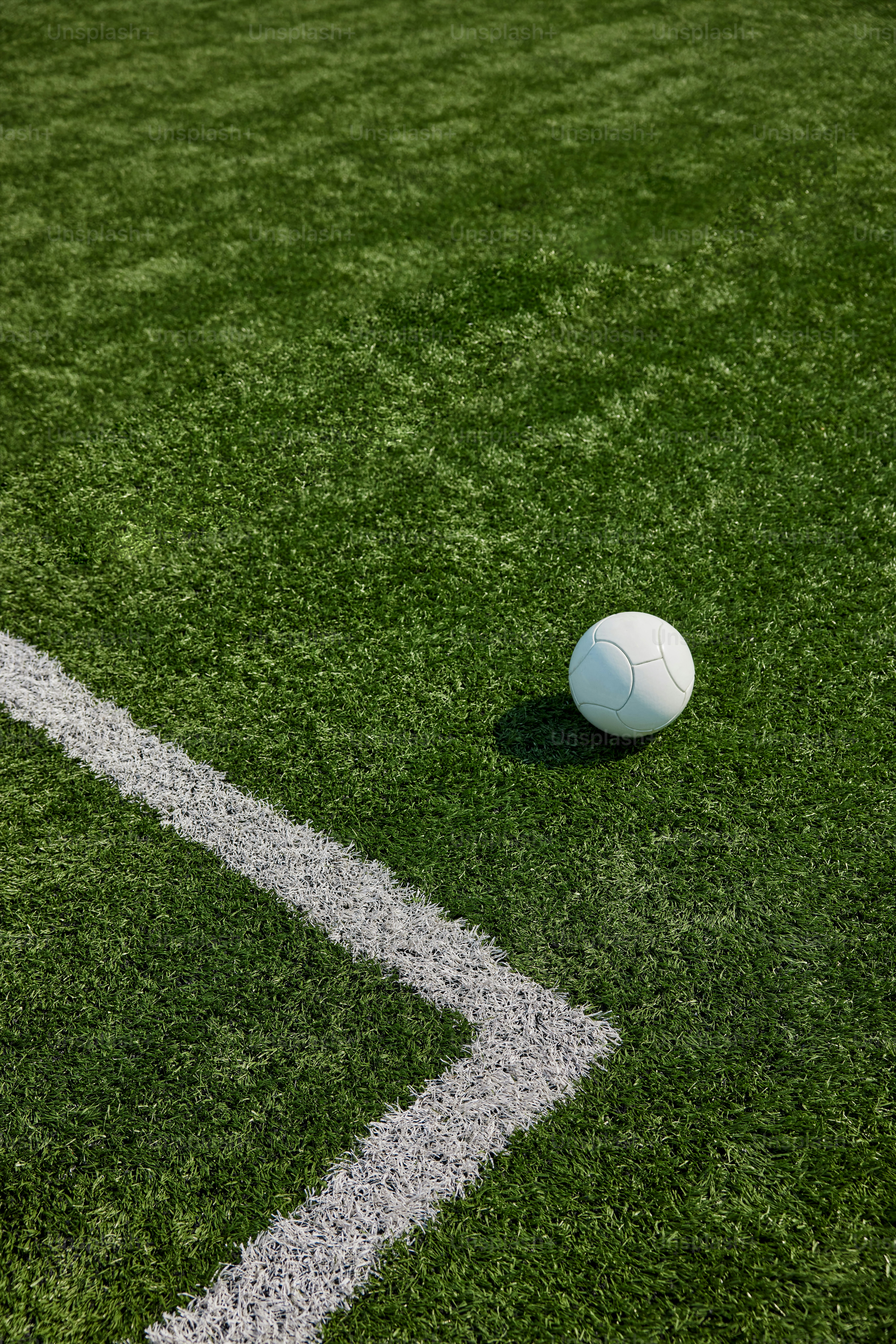a white soccer ball sitting on top of a green field