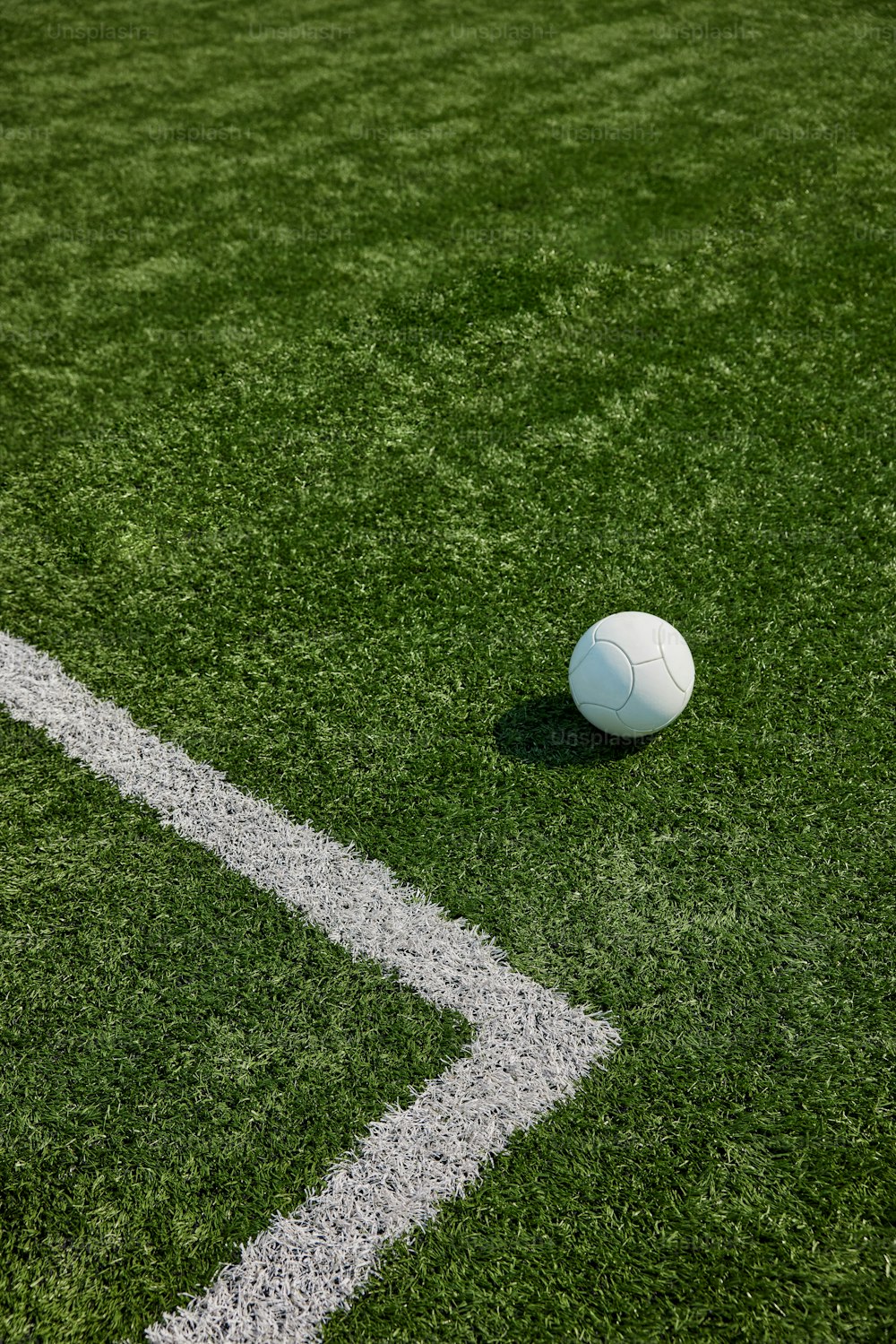 a white soccer ball sitting on top of a green field