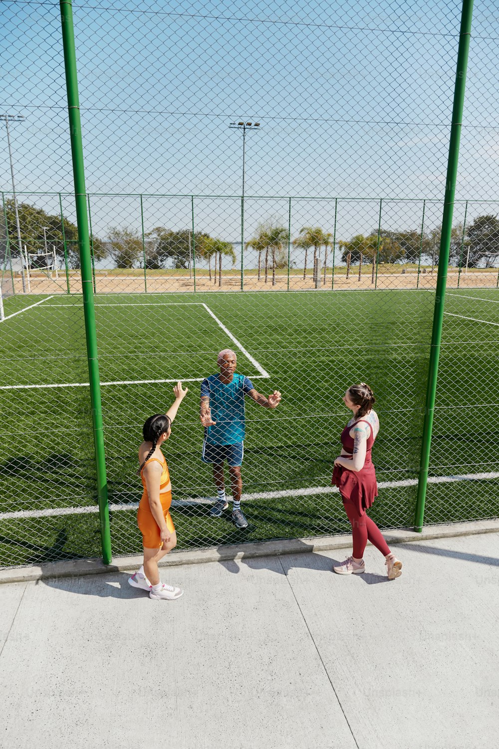 a group of people standing on top of a soccer field