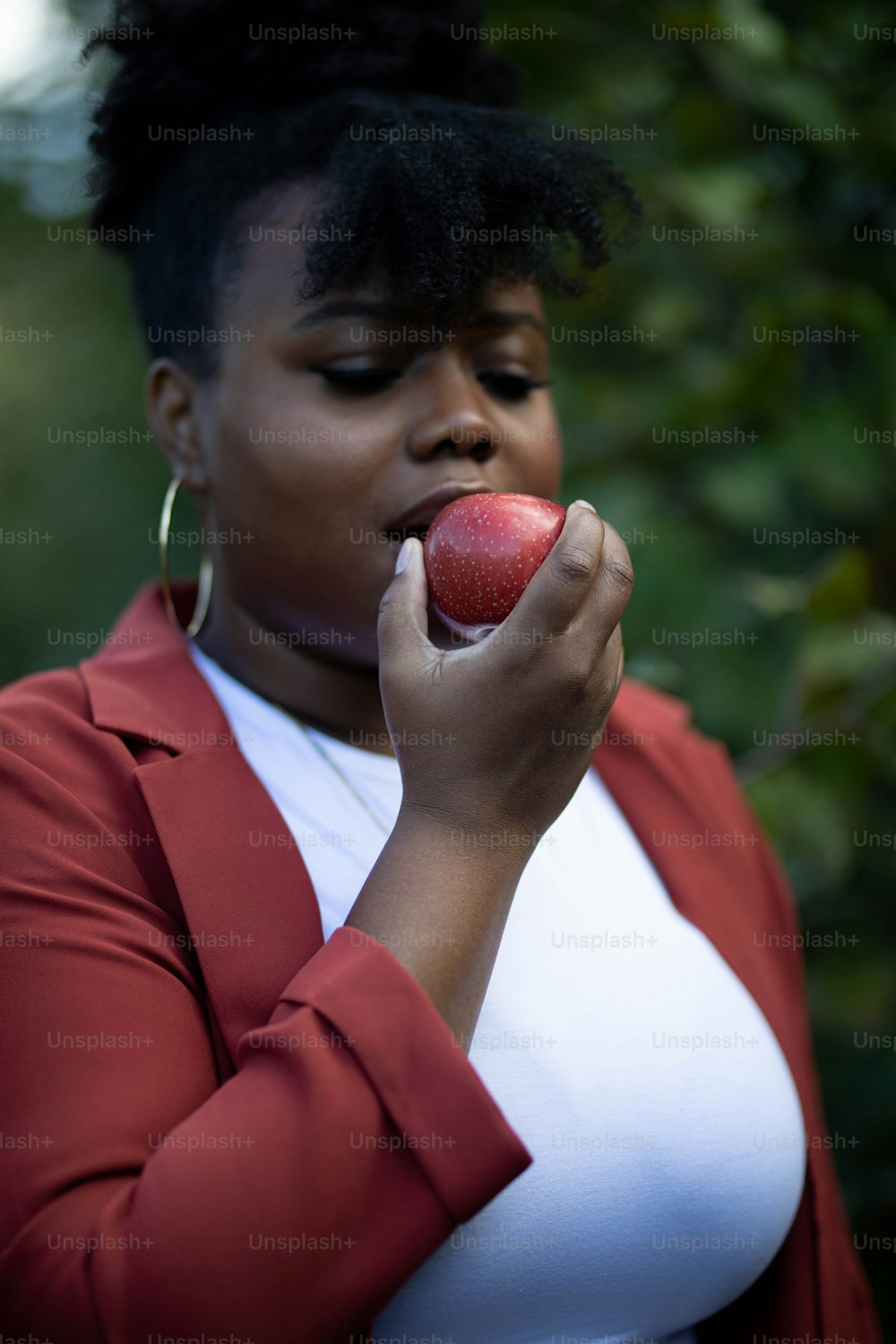 a woman holding an apple in her right hand