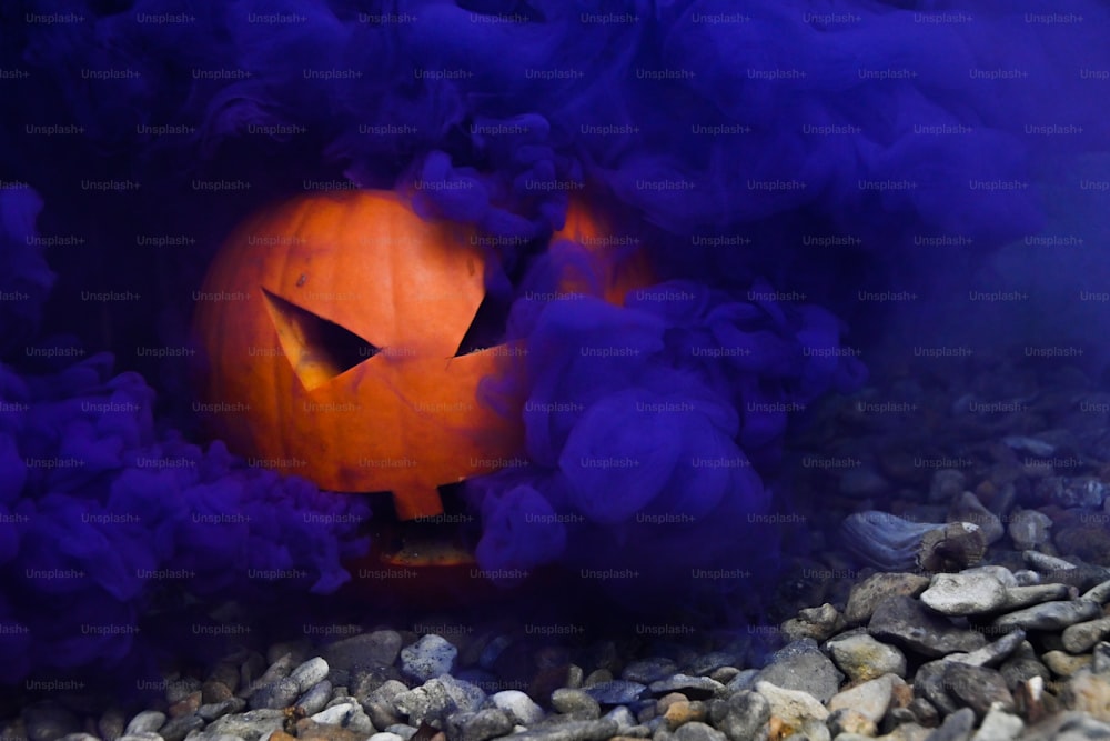 a halloween pumpkin with smoke coming out of it