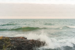 a person riding a surfboard on top of a wave