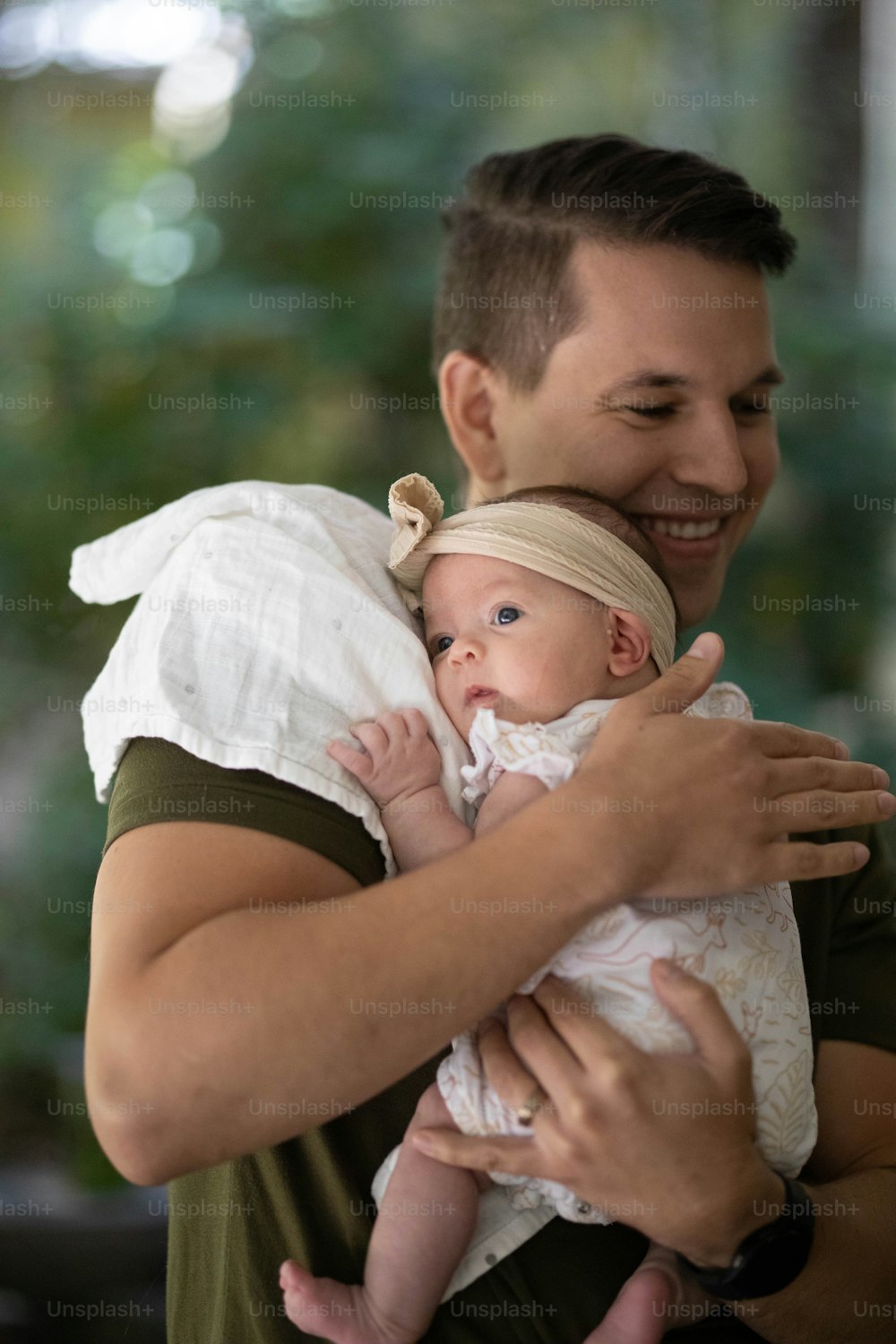 a man holding a baby in his arms